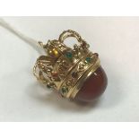 An eighteen carat gold and stone set pendant in the form of a crown