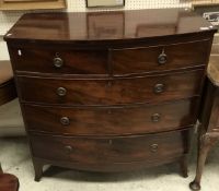 A Victorian mahogany bow-fronted chest of two short over three long drawers to bracket feet