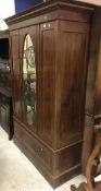 An Edwardian mahogany and inlaid single mirror door wardrobe with drawer,