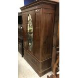 An Edwardian mahogany and inlaid single mirror door wardrobe with drawer,