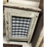 A Continental painted pine single door cupboard with wirework and fabric-covered panel as a meat