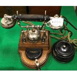 An early 20th Century Swedish oak-cased telephone with integral bell by Karlsens Elektriske