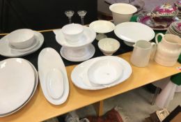 A collection of various cream/white glazed serving wares including White Company oval serving