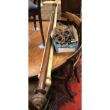 A mahogany curtain pole and box of various curtain rings,