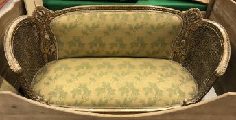 A 19th Century gilt framed salon settee with bergere side panels and upholstered back and seat in
