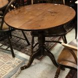 An oak circular pedestal tripod table in the 18th Century manner