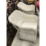 Two white painted wicker Lloyd Loom style chairs