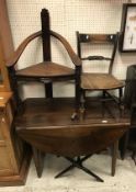 A 19th Century French walnut drop leaf dining table on turned tapering legs and a carved oak corner