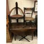 A 19th Century French walnut drop leaf dining table on turned tapering legs and a carved oak corner