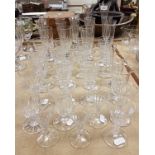 A collection of eleven various flutes and twenty-six further facet cut stemmed drinking glasses,