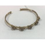 A nine carat gold and pink and white stone set bangle in the Victorian taste