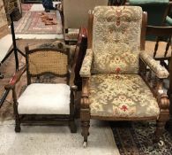 A Victorian open arm chair with floral upholstered arms raised on ringed and turned front legs to