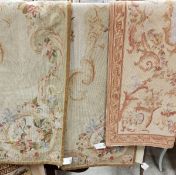 Three needlework panels in the Aubusson manner each with floral decoration,