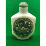 An early 20th Century Chinese porcelain snuff bottle with dragon decoration