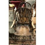 A pair of oak wheel back elbow chairs together with a three tier cake stand