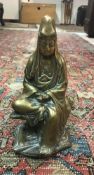 A Chinese bronze figure of Guan Yin seated with scroll in her hands,