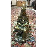 A Chinese bronze figure of Guan Yin seated with scroll in her hands,