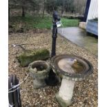 A pair of composite stone garden urns, together with a similar bird bath,