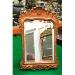 A 19th Century gilt and gesso framed mirror mounted on easel back