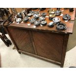 A Victorian pitch pine saddle horse with fold-over top over two end drawers and two cupboard doors