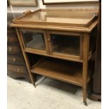 A circa 1900 Dutch oak and inlaid tea trolley with lift-out scroll-handled tray over two