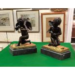 A pair of 19th Century Continental chocolate patinated bronze figures of cherubs,