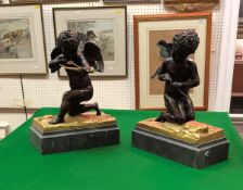 A pair of 19th Century Continental chocolate patinated bronze figures of cherubs,