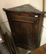 An early 19th Century oak and cross-banded North Country hanging corner cupboard,