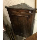 An early 19th Century oak and cross-banded North Country hanging corner cupboard,