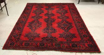 A Turkish style carpet, the repeating pattern on a red ground within a red,