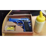 An HFC spring powered Airsoft 6 mm air pistol with synthetic ammo