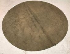 A modern circular rug of plain taupe colour, approx.