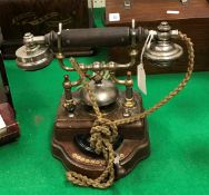 An early 20th Century Swedish oak-cased telephone with integral bell by Karlsens Elektriske