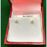A pair of diamond ear studs in 9 carat gold mounts