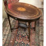 An oval mahogany inlaid two tier occasional table