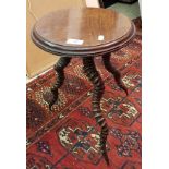 A circa 1900 mahogany circular occasional table on three twisted horn base CONDITION