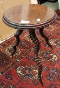 A circa 1900 mahogany circular occasional table on three twisted horn base CONDITION