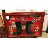 A framed and glazed diorama of hunting boots, trophy, stirrups, bit and spurs,