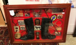A framed and glazed diorama of hunting boots, trophy, stirrups, bit and spurs,