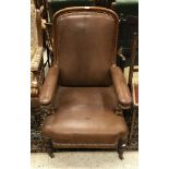 A Victorian reclining open arm elbow chair with brown leather upholstery and mahogany frame with