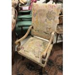 An early 20th Century walnut framed armchair with needlework back and seat,