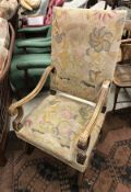An early 20th Century walnut framed armchair with needlework back and seat,