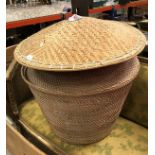 A cane work lidded basket together with three caned hats of small proportion and a larger hat,