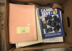 A box containing various magazines and manuals relating to camera equipment including Rolleiflex,