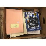 A box containing various magazines and manuals relating to camera equipment including Rolleiflex,