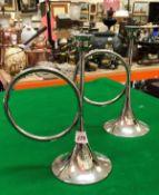 A pair of plated candlesticks in the form of hunting horns together with a mantel clock with