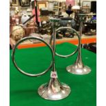 A pair of plated candlesticks in the form of hunting horns together with a mantel clock with