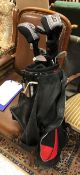 A golf bag and contents of Texan Titanium Matrix golf clubs including three drivers,