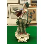 A 19th Century Continental porcelain figure of a gentleman in gilt decorated costume with dog at