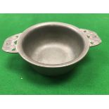 An Art Nouveau style pewter quaich by Liberty & Co No'd 01285 to base designed by Archibald Knox